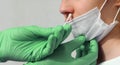 Doctor performing a nasal swab test for the detection of the Coronavirus virus to the young girl with