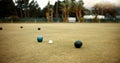 Green, lawn bowling and balls on grass, field or pitch in a match, game or competition of outdoor bowls. Ball, sport and Royalty Free Stock Photo