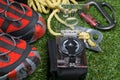 On the green lawn, close-up, set for the traveler, comfortable shoes, compass, rope and carabiners