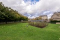 A green lawn and flower beds at Square de IÃ¢â¬â¢lle-de-France near Deportation Martyrs memorial, Paris