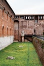 Green lawn near the wall of the Castello Sforzesco. Milan, Italy Royalty Free Stock Photo