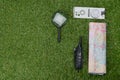 On the green lawn, there are items for the traveler, a magnifying glass, a map, a radio, a compass, on the left there is a place Royalty Free Stock Photo