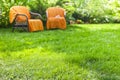 Green lawn with two wicker chairs in the garden Royalty Free Stock Photo