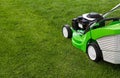 Green lawnmower on green lawn