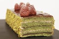 Green layered cake with pistachio and raspberries