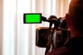 Green LCD display on high definition television camera. Videographer at work removes the story for the news. Template template for Royalty Free Stock Photo