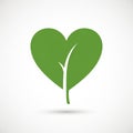 A green leaf is designed in the shape of a heart against a white background. A white Royalty Free Stock Photo