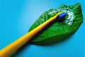 on a green leaf from a flower lies a bright toothbrush and a plastic bracket, close-up on a blue background