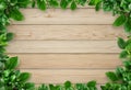 Green leafy border around the wooden background