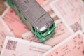 A green leather train model on a background of a pile of train tickets Royalty Free Stock Photo