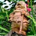 Ceramic dwarf. Green leave in the garden, in springtime Royalty Free Stock Photo