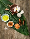 Green leaves with nature spa ingredients turmeric,herbal compress ball,dried indian bael ,cinnamon powder ,cinnamon sticks Royalty Free Stock Photo