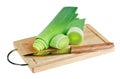 Green leek with knife on wooden chopping board