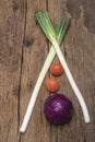 Green leek tomato purple cabbage vegetable food on wood table