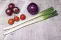 Green leek tomato purple cabbage vegetable food on wood table