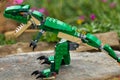 Green Lego Dinosaur With Jaws Wide Open and Pointed White Teeth.