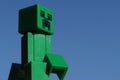 Green Lego Minecraft Creeper figure in morning sunshine.