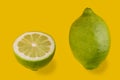 Green lemon isolated on yellow background