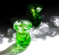 Green lemonade with ice and kiwi slices.Glass glasses stand on the table and the sun`s rays fall on them Royalty Free Stock Photo