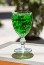 close-up Green lemonade Tarragon in a glass glass on a blurry background. Green drink from healthy herbs Tarragon