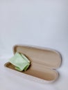 Green lens cleaner fabric inside opened spectacle case Royalty Free Stock Photo