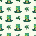 Green leprechaun top hats with clover leaves. Seamless vector pattern. Headdress with golden buckle and quatrefoil Royalty Free Stock Photo