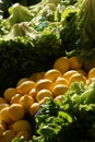 Green lettuce and heaps of yellow lemons. views of the organic food market