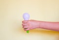 Green Light bulb on yellow background. Hand holds lamp. Free copy space. Concept of new idea, green energy Royalty Free Stock Photo