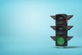 Green light on stack of black loudspeakers