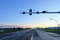 A green light at a traffic light along a highway at  dusk Royalty Free Stock Photo