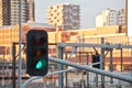 Green light traffic signal with contemporary train station background Royalty Free Stock Photo
