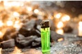 The green lighter On a black background with charcoal and orange bokeh Royalty Free Stock Photo