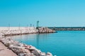 A green lighthouse on the pier of Pesaro harbor with tetrapod breakwaters Italy, Europe Royalty Free Stock Photo