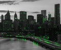 Green lights shining in black and white cityscape with the downtown Manhattan skyline buildings of New York City at night time Royalty Free Stock Photo