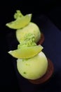 Green lime desserts on chocolate cookie with fresh lime slices and pistachio sponge Royalty Free Stock Photo