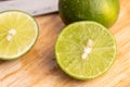 Green lime and seed with a knife place on wooden board in a kitchen Royalty Free Stock Photo
