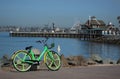 A green Limebike is parked in front of San Diego`s Seaport Village Royalty Free Stock Photo