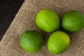 Green limes on a jute table cloth Royalty Free Stock Photo