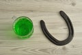 Green liquid in a beer mug with a horseshoe Royalty Free Stock Photo