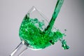 Green liquid puring in to a glass