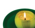 Green lit candle macro closeup, isolated glowing flame Royalty Free Stock Photo