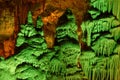 Green-lit stalagmite shapes in Soreq Cave, Israel