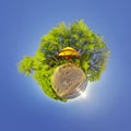 Green little planet with trees and soft blue sky. Tiny planet sunset at the beach. 360 viewing angle. Planet Earth.
