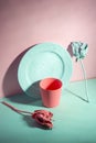 green and living coral color minimalist still life of dishes and roses painted