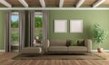 Green living room with modern sofa and footstool