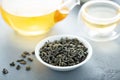 Green loose leaf tea and a teapot Royalty Free Stock Photo