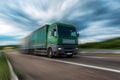 Green Lorry truck speeding on freeway at sunset