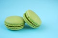 Green macarons on blue background