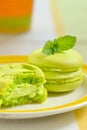 Green macaroon with mint leaves