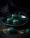 Green macaroons on a plate on a black background. French dessert.